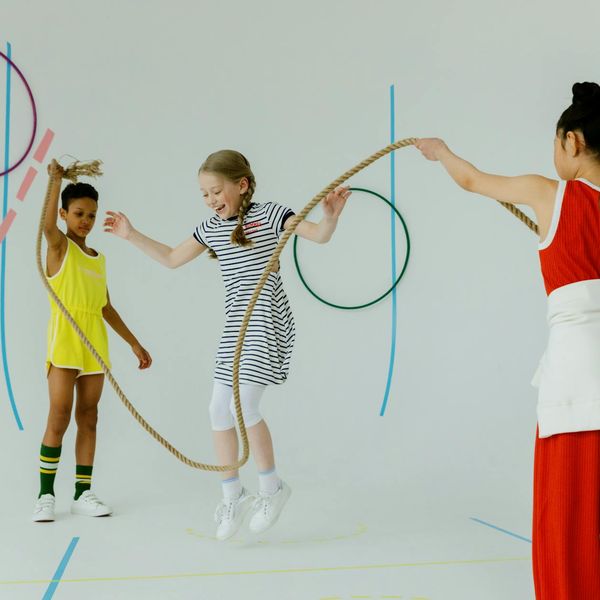 Hands holding a skipping rope on dark background